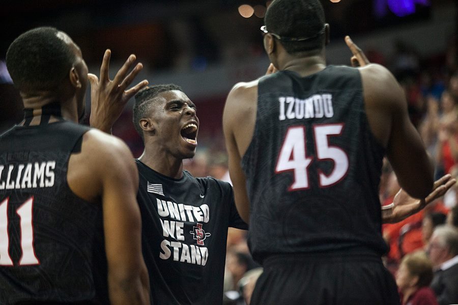 Junior forward Zylan Cheatham celebrates with senior guard D'erryl Williams and senior center Valentine Izundu.