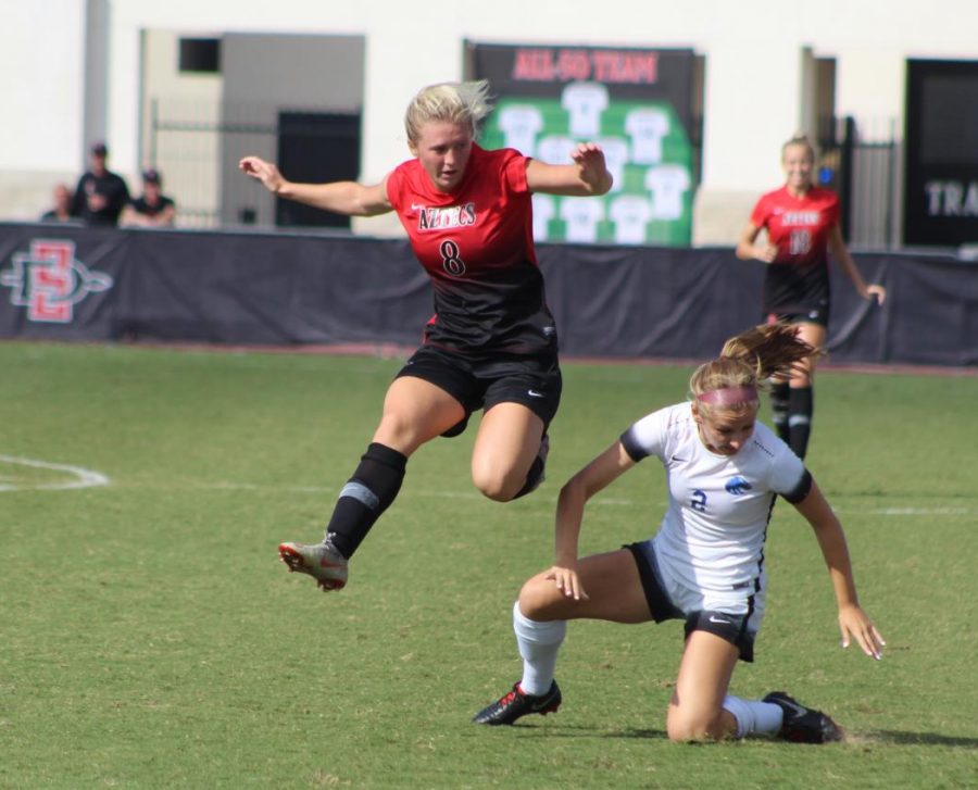 Sophomore forward Chloe Frisch leaps around a Boise State defender during the Aztecs 1-0 loss to the Broncos on Oct. 7 at the SDSU Sports Deck.