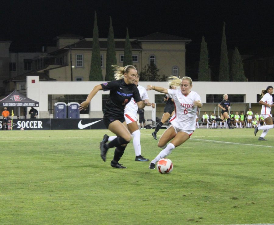 Senior defender Malia Kaleiohi (6) chases down Boise State sophomore Mia Burns (9).