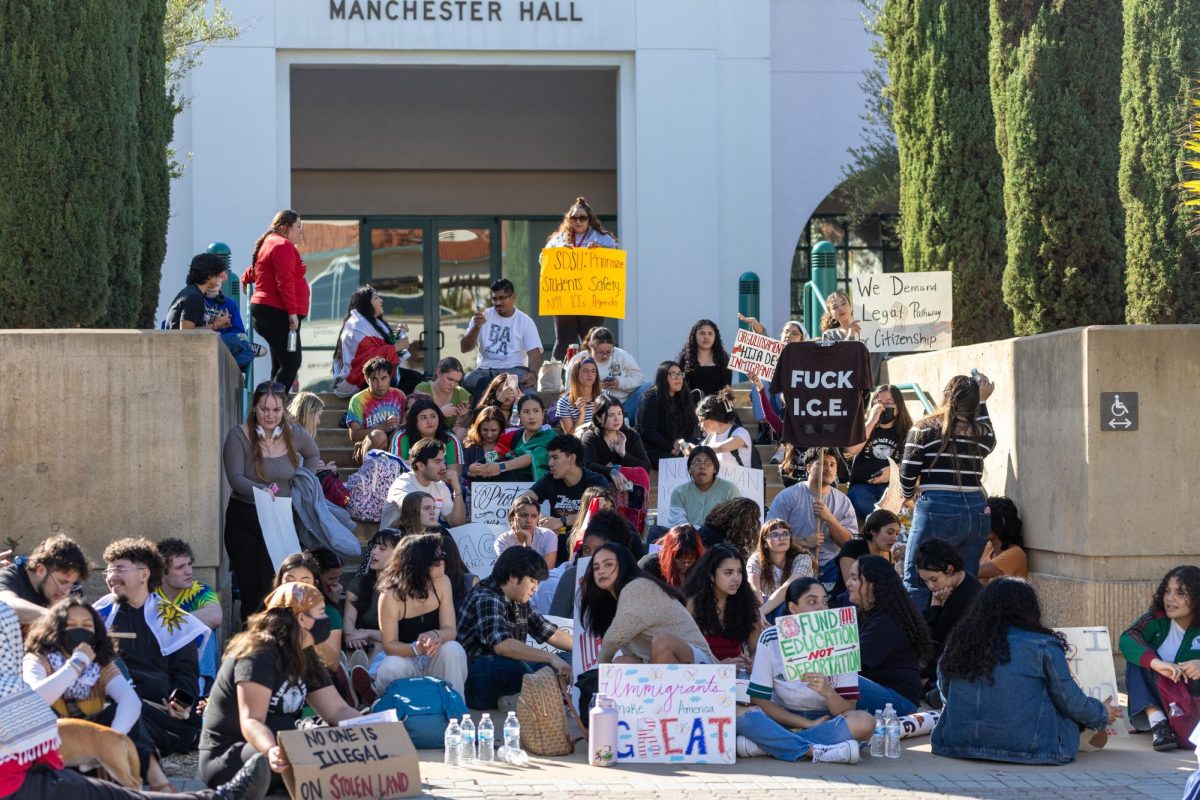 Protestors sit outside Manchester Hall where San Diego State University President's office is on Thursday, Feb. 20, 2025.