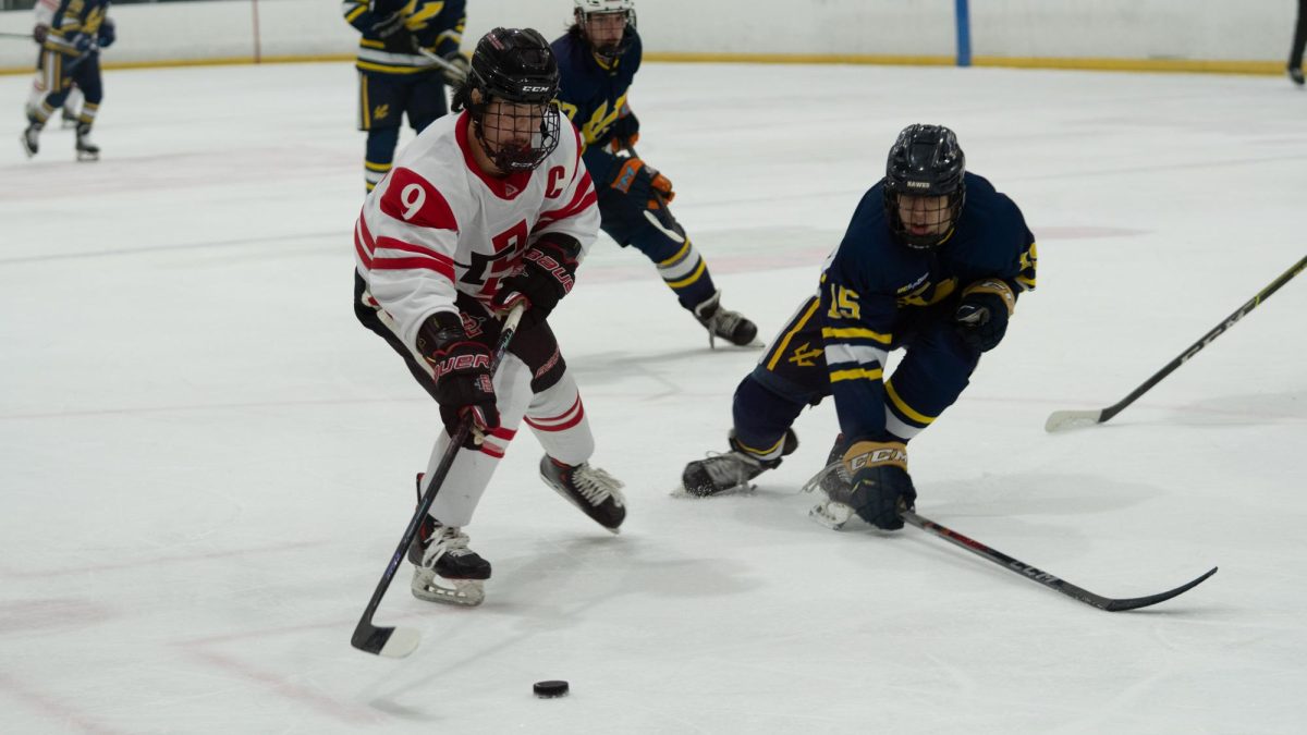 San Diego State senior forward Marcus Kim rushes the puck down the rink on Feb. 22, 2025 at Kroc Ice Arena.
