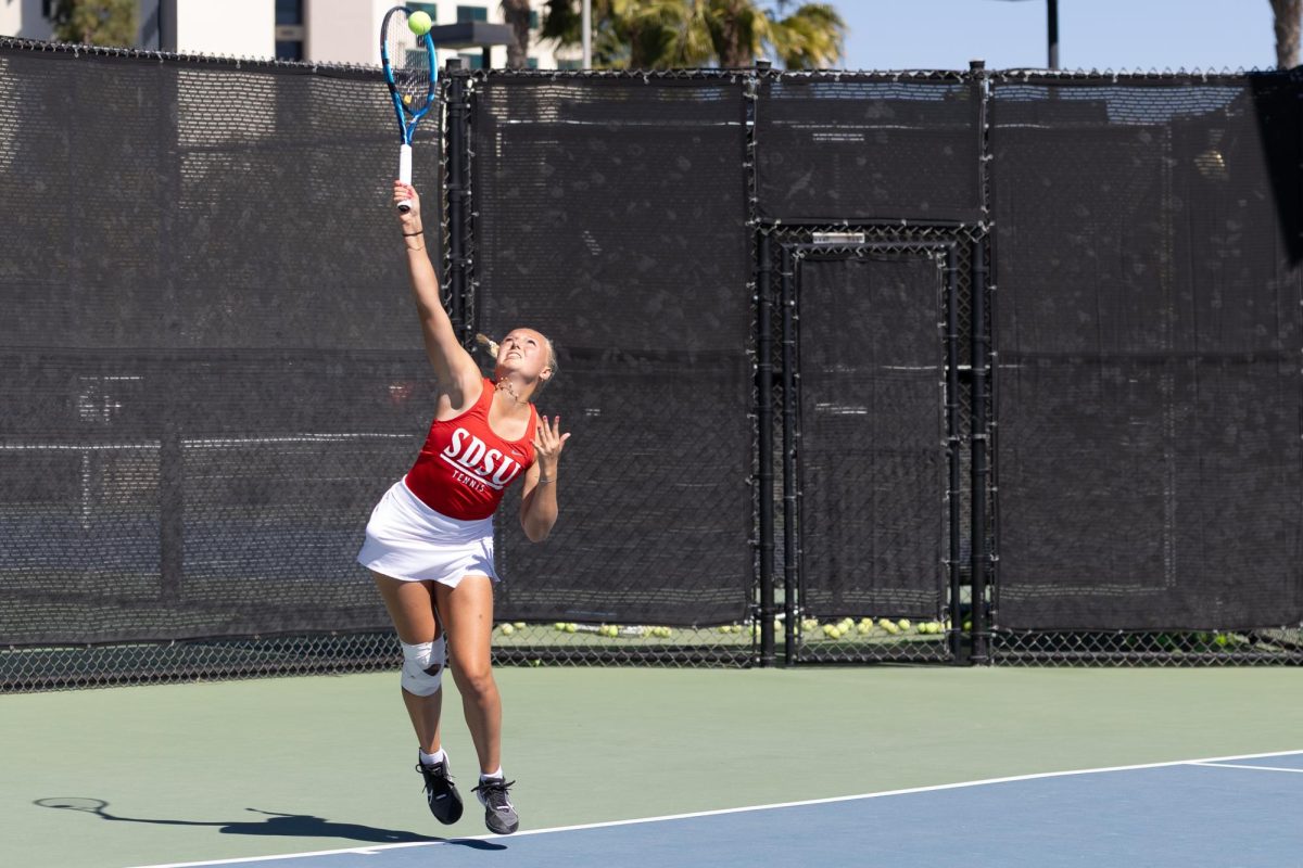 San Diego State women's tennis player Ninon Martinache serves against Hawaii on Sunday, Feb. 23, 2025, at the Aztec Tennis Center in San Diego.  