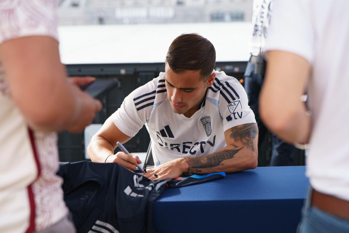 Tomás Ángel signs a fan's jersey at the San Diego FC kickoff party at Snapdragon Stadium on Feb. 16. 