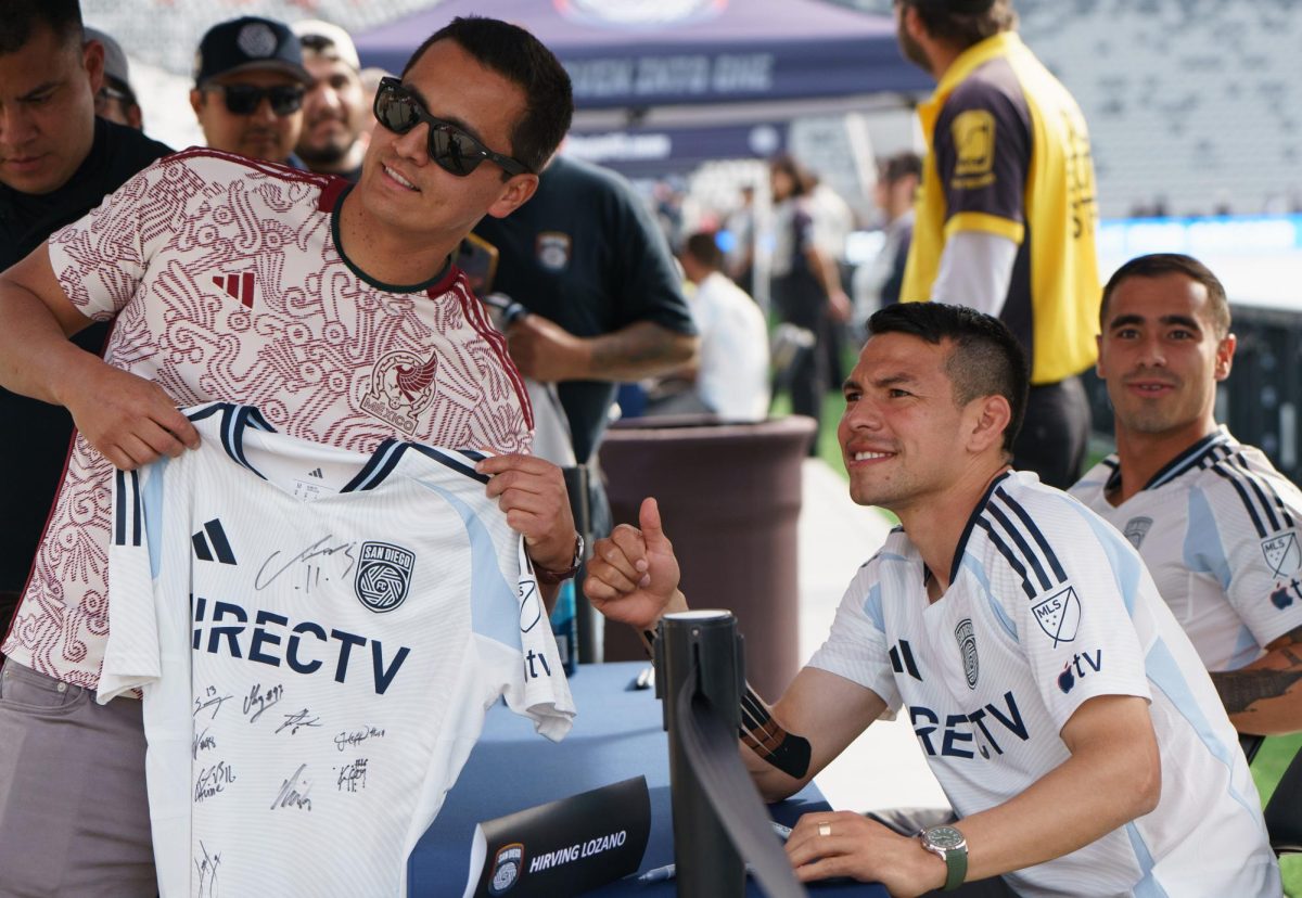 Hirving "Chucky" Lozano takes a photo with a fan after he signs his jersey at the San Diego FC kickoff party at Snapdragon Stadium on Feb. 16. 