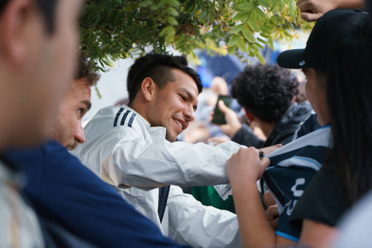 Hirving "Chucky" Lozano gets swarmed by fans, almost knocking down the barricade, while autographing fans' merchandise after his Q&A session at the San Diego FC kickoff party at Snapdragon Stadium on Feb. 16. 