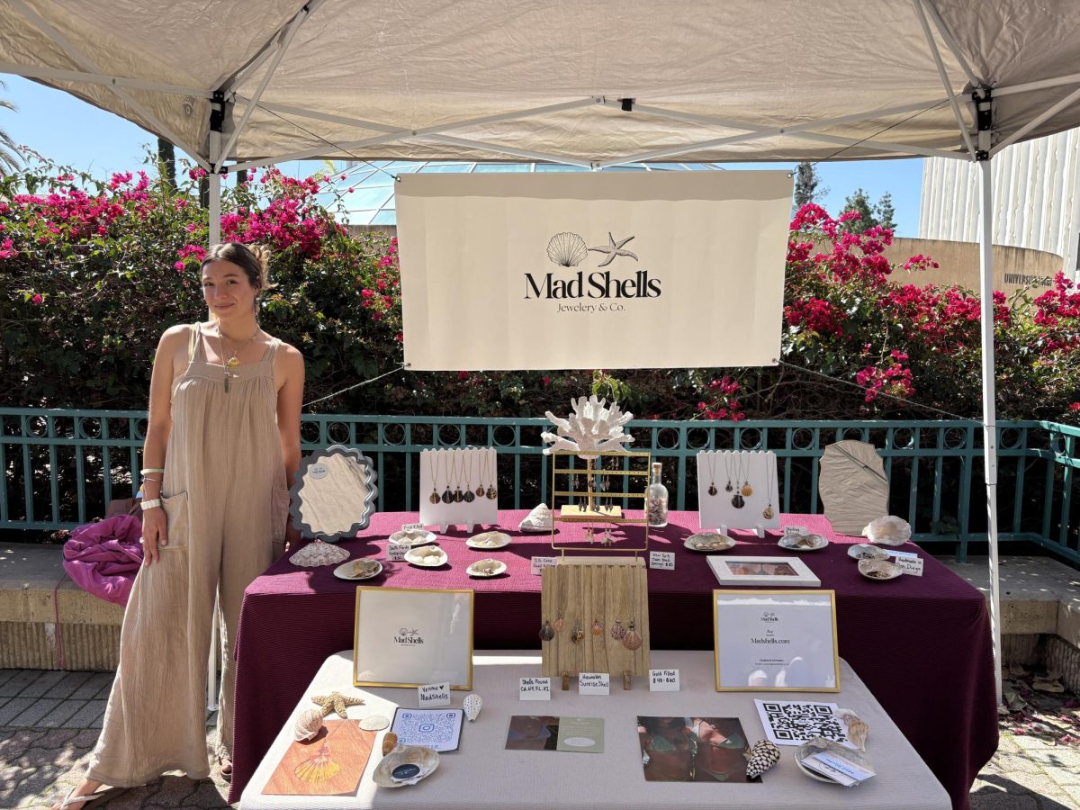 Madison Feinstein stands with her Mad Shells table at San Diego State University on March 20, 2025.