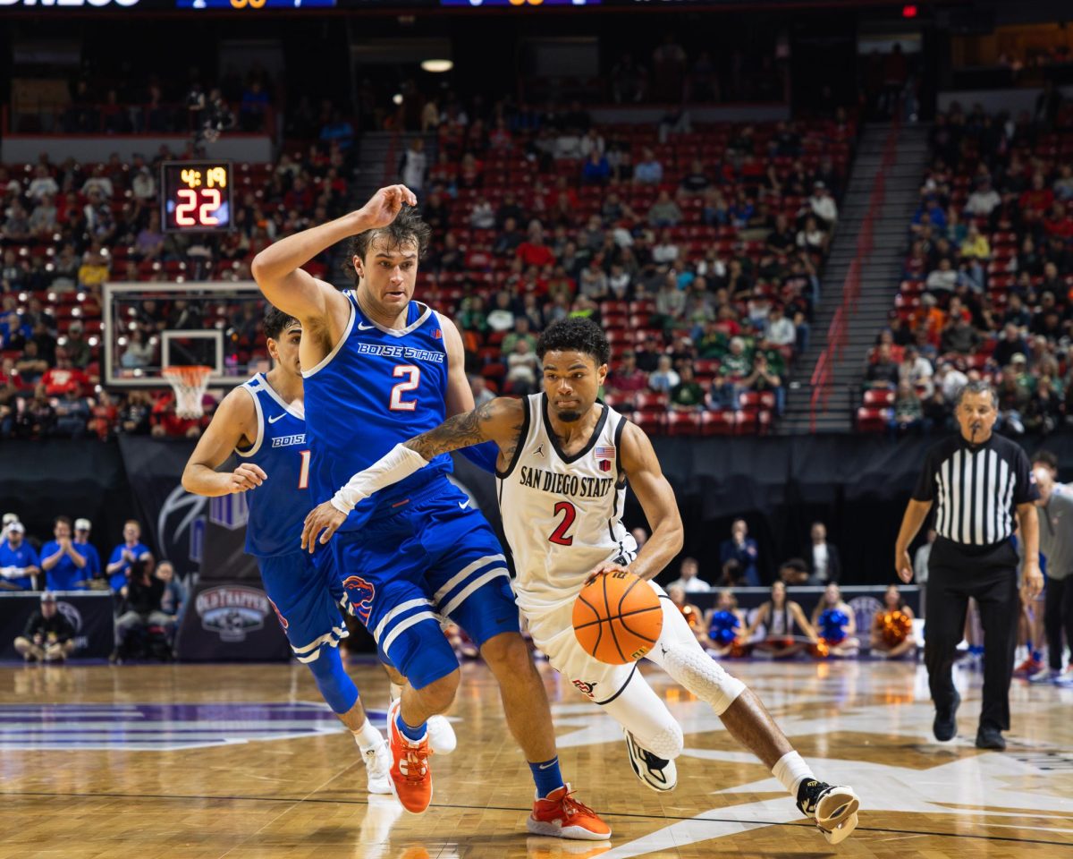 Guard Nick Boyd drives on Center Tyson Degenhart during the Aztecs Quarter-Final matchup with Boise State on Mar. 13, 2025 in the Thomas and Mack Center in Las Vegas, Nevada
