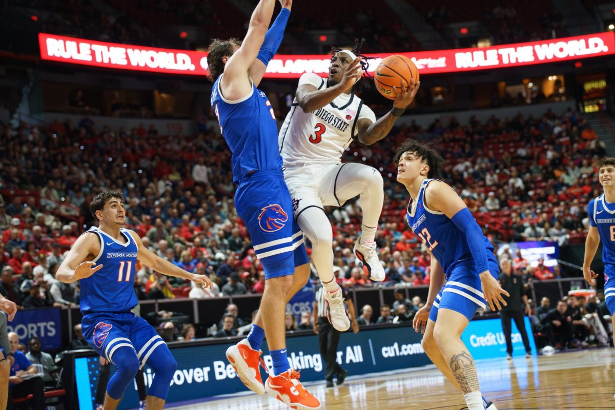 San Diego State guard Wayne McKinney III attempts a shot past Boise State forward Tyson Degenhart during the Mountain West Quarterfinal in Las Vegas at the Thomas & Mack Center on March 13, 2025.