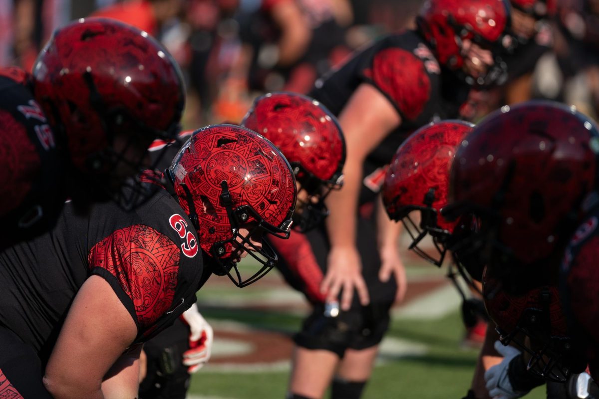 San Diego State offensive lineman run drills before a game last season at SnapDragon Stadium. 
